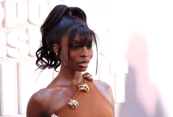 Olandria Carthen wears a oneshoulder dress and high ponytail on the red carpet at the Sports Illustrated Swimsuit party.